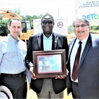 Jorge Ayala receives framed photo of SA water tanks & thank you